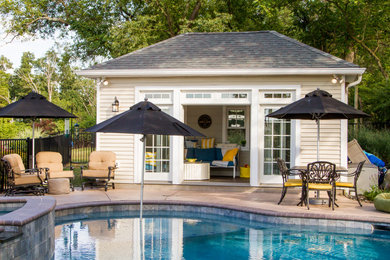 Example of a mid-sized beach style backyard custom-shaped pool house design in Philadelphia