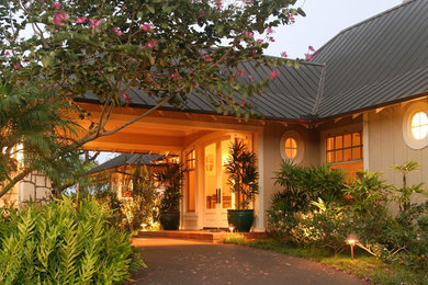 Inspiration for a mid-sized timeless concrete floor and brown floor entryway remodel in Hawaii with beige walls and a white front door