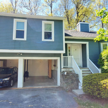 Before picture with bushes blocking entry and windows