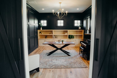 Inspiration for a mid-sized transitional open concept living room in Atlanta with a music area, black walls, light hardwood floors, no fireplace, no tv and beige floor.