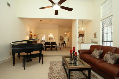 Mid-sized elegant open concept carpeted and beige floor family room photo in Dallas with beige walls, a standard fireplace, a stone fireplace and no tv