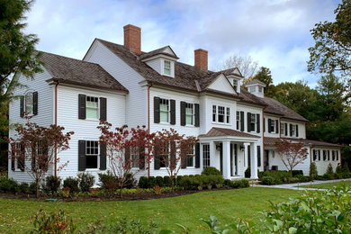 Inspiration for a large timeless white three-story wood exterior home remodel in Boston with a shingle roof and a brown roof