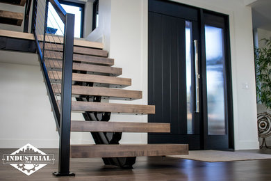 Mid-sized minimalist wooden floating open and metal railing staircase photo in Portland