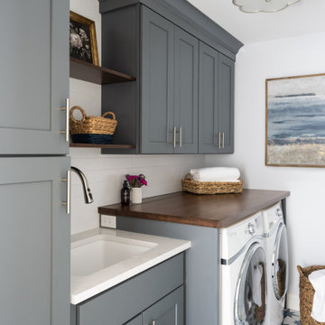 Laundry Room with statement tile and cabinets galore