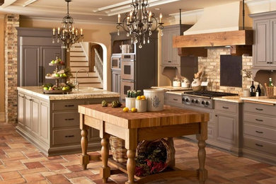 Large country u-shaped separate kitchen in Other with a farmhouse sink, raised-panel cabinets, grey cabinets, granite benchtops, beige splashback, brick splashback, panelled appliances, travertine floors and multiple islands.