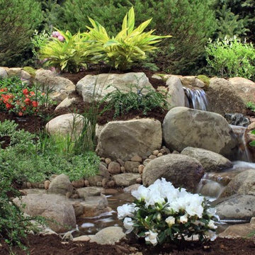 Landscaping and backyard waterfall with stream