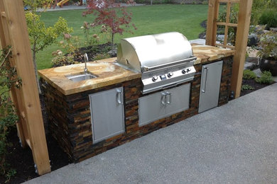 Patio kitchen - traditional backyard patio kitchen idea in Seattle with no cover