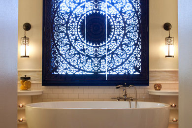 Example of a large eclectic master white tile and ceramic tile marble floor freestanding bathtub design in Los Angeles with a console sink, furniture-like cabinets, white cabinets, a two-piece toilet and beige walls