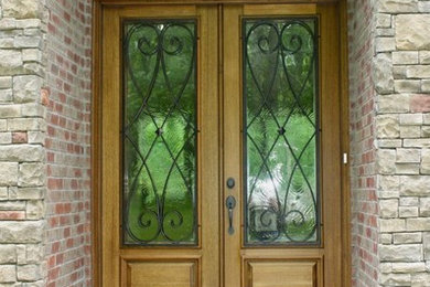Photo of an entryway in Nashville with brick floors, a double front door and a light wood front door.