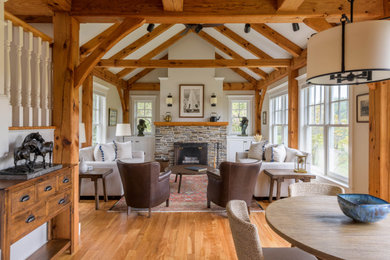 Example of a transitional living room design in Burlington with a stone fireplace