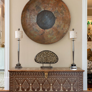 Photo of a large eclectic vestibule in Dallas with beige walls, dark hardwood floors, a single front door and a dark wood front door.