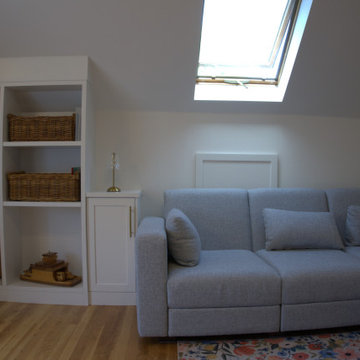 Bright Attic Lounge with Custom Storage & Skylight