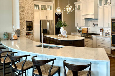 Eat-in kitchen - transitional eat-in kitchen idea in Orlando with recessed-panel cabinets, white cabinets, quartz countertops, white backsplash, porcelain backsplash, stainless steel appliances, two islands and white countertops
