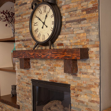 Interior remodel including flooring, stone wall, and lighting.