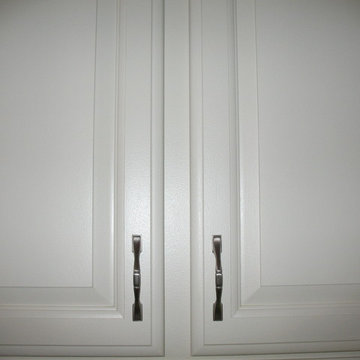 Medium color wood to off white with white subway tile and granite counter tops
