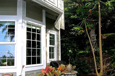 Large gray two-story exterior home photo in Hawaii