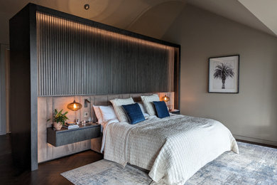 This is an example of a large contemporary master bedroom in Surrey with feature lighting.