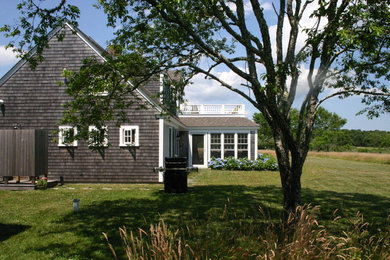 Example of a beach style home design design in Boston