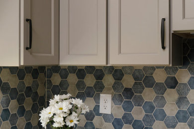 Inspiration for a small transitional u-shaped vinyl floor and brown floor eat-in kitchen remodel in Atlanta with an undermount sink, recessed-panel cabinets, beige cabinets, quartz countertops, blue backsplash, porcelain backsplash, stainless steel appliances, no island and white countertops