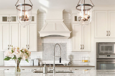 Inspiration for a large country kitchen remodel in Hawaii with an undermount sink, shaker cabinets, white cabinets, granite countertops, white backsplash, stainless steel appliances and an island