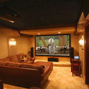 Photo of a traditional enclosed home cinema in DC Metro with carpet and a projector screen.