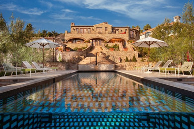 This is an example of an expansive contemporary backyard rectangular lap pool in Orange County with a hot tub and concrete slab.