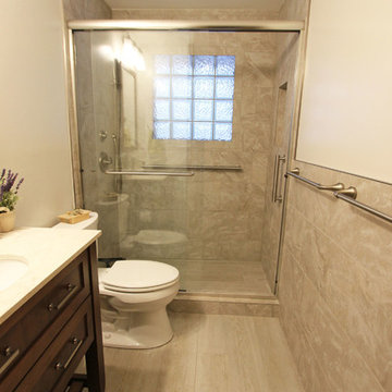 Beige Tiled Shower and Free Standing Vanity with Quartz Countertop