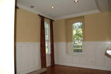 Living room - mid-sized traditional formal and enclosed medium tone wood floor and brown floor living room idea in Sacramento with yellow walls, a standard fireplace, a stone fireplace and no tv