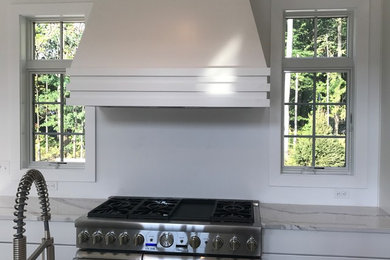 Kitchen - transitional kitchen idea in Cleveland with white cabinets, quartz countertops, stainless steel appliances and white countertops