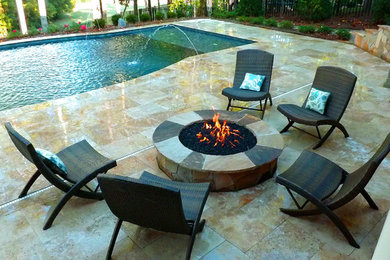 Example of a large trendy backyard tile and custom-shaped lap pool fountain design in Charlotte