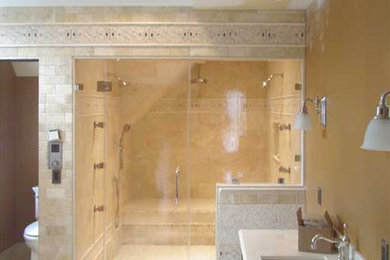 Example of a master beige tile and stone tile walk-in shower design in New York with an undermount sink, a two-piece toilet and yellow walls