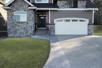 Inspiration for a mid-sized timeless gray two-story stone exterior home remodel in Vancouver