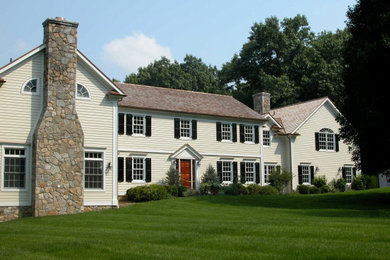 Mid-sized traditional beige two-story wood exterior home idea in New York with a shingle roof
