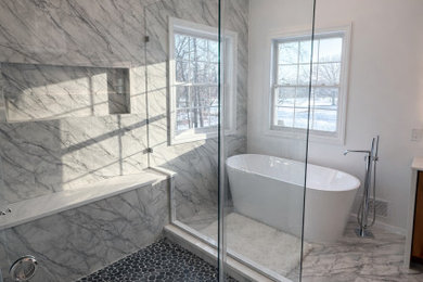 Large trendy master white tile and marble tile marble floor, white floor and double-sink bathroom photo in Philadelphia with shaker cabinets, medium tone wood cabinets, a one-piece toilet, white walls, a drop-in sink, quartzite countertops, white countertops, a niche and a built-in vanity