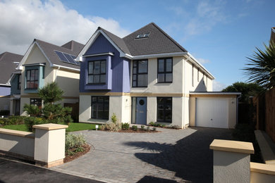 This is an example of a medium sized nautical house exterior in Hampshire with three floors and concrete fibreboard cladding.