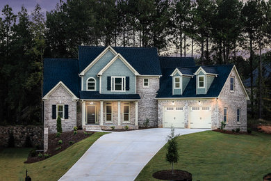 Inspiration for a mid-sized timeless beige two-story brick exterior home remodel in Atlanta with a shingle roof