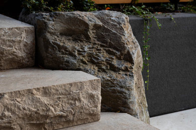 Inspiration for a small scandinavian drought-tolerant, rock and shade front yard stone and wood fence landscaping in Vancouver for fall.