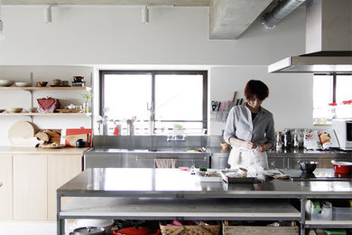 Inspiration for an industrial kitchen in Nagoya with flat-panel cabinets, stainless steel benchtops and with island.