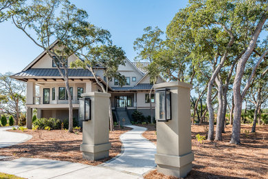 Huge modern brown three-story mixed siding exterior home idea in Charleston with a metal roof