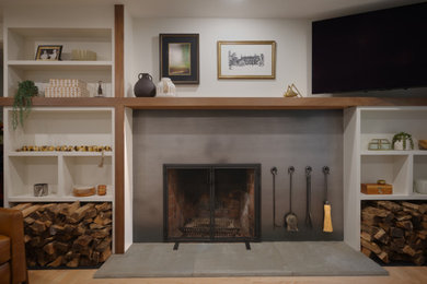 Living room - 1960s light wood floor and brown floor living room idea in Boston with gray walls, a wood stove, a metal fireplace and a wall-mounted tv