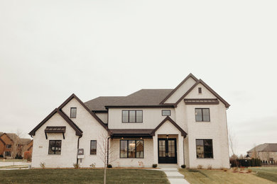 Transitional white two-story board and batten house exterior photo in Chicago with a mixed material roof and a black roof