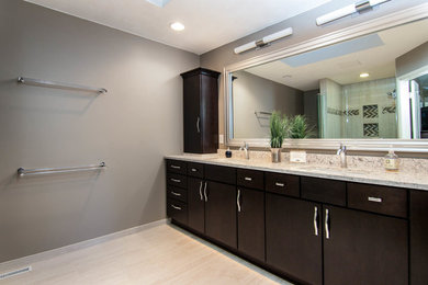 Large trendy master gray tile and porcelain tile porcelain tile and gray floor corner shower photo in Chicago with flat-panel cabinets, dark wood cabinets, a two-piece toilet, gray walls, an undermount sink, quartzite countertops and a hinged shower door
