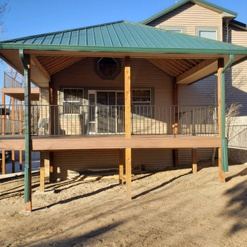 Two level deck with roof on one end, dryspace under deck on the other end