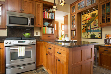 Large arts and crafts u-shaped eat-in kitchen in Minneapolis with an undermount sink, shaker cabinets, medium wood cabinets, quartz benchtops, stainless steel appliances, slate floors and a peninsula.