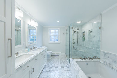Corner shower - mid-sized traditional master white tile and marble tile marble floor and white floor corner shower idea in Boston with shaker cabinets, white cabinets, an undermount tub, a two-piece toilet, gray walls, an undermount sink, marble countertops, a hinged shower door and white countertops