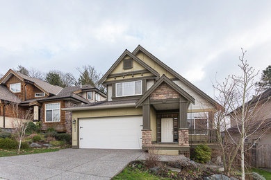 Large elegant green three-story gable roof photo in Vancouver