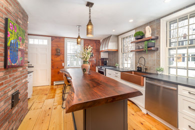 Mid-sized traditional separate kitchen in Boston with an undermount sink, white cabinets, wood benchtops, metallic splashback, metal splashback, stainless steel appliances and brown benchtop.