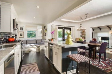 Inspiration for a mid-sized contemporary dark wood floor and brown floor open concept kitchen remodel in Los Angeles with an undermount sink, shaker cabinets, white cabinets, marble countertops, black backsplash, subway tile backsplash, stainless steel appliances, an island and gray countertops
