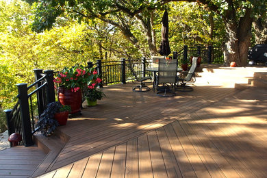 Example of a large trendy backyard deck design in Other with no cover