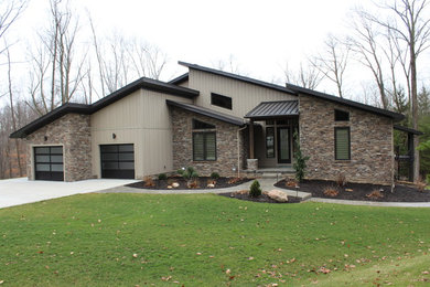 Example of a mid-sized trendy beige one-story mixed siding exterior home design in Cleveland with a shed roof